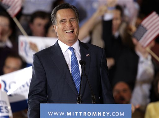 Romney smiles as he addresses supporters at his Super Tuesday campaign ...